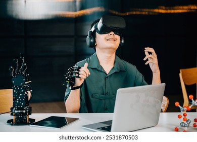 Asian teenager experiments with a robot arm project using VR glasses in a classroom. Embracing robotics programming merging technology and STEM education for futuristic learning. moves a robotic hand