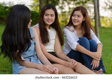 Asian Teenager Friends Talking Outdoors In Park