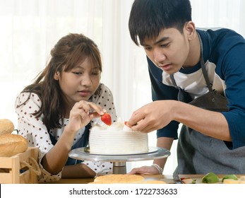 Asian Teenager Girl And Boy Learning How To Decorating Cake At Home, Lifestyle Concept.