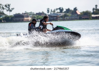 Asian Teenager On Jet Ski With Trainer. Teen Age Boy Skiing On Wave Runner. Young Man On Personal Watercraft In Tropical Sea. Jetski Training. Sport And Ocean Activity On Beach Holiday.