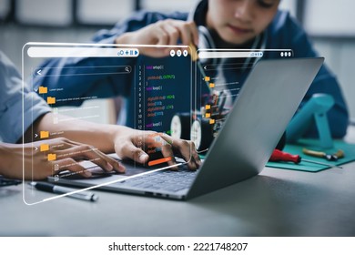 Asian teenager students doing robot arm and robotic cars homework project in house using computers and coding. technology of robotics programing and STEM education concept. - Shutterstock ID 2221748207