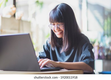 Asian Teenager Studying Online On Laptop Computer At Home 