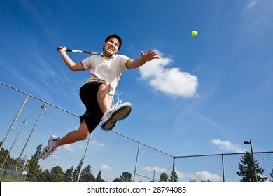 An asian tennis player jumping in the air hitting a tennis ball - Powered by Shutterstock