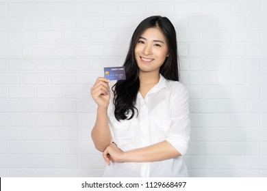 Asian Thai Elegant Black Girl Blouse In Home Holding   Credit-card Signing Up On A Website Application. Business Woman Paying With A Credit Card While Shopping Online  