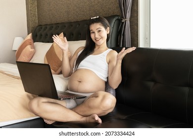 Asian Thai Pregnant Mother Using A Computer For Online Shopping Very Happy. Concept Of Buying Baby Supplies