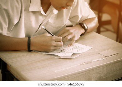 Asian, Thai Students Writing On A Paper For Exams And Admissions In High School, Thailand