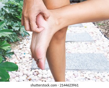 Asian Thai Women Barefoot With Itchiness On Foot And Scratching On Soles Of Feet.