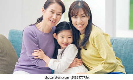 Asian Three Generation Female Family Looking At Camera.