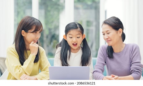 Asian Three Generation Female Family Watching A PC. Video Distribution Service.