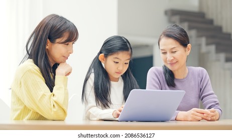 Asian Three Generation Female Family Watching A PC. Video Distribution Service.