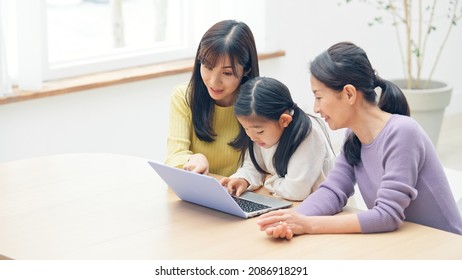 Asian Three Generation Female Family Watching A PC. Video Distribution Service.