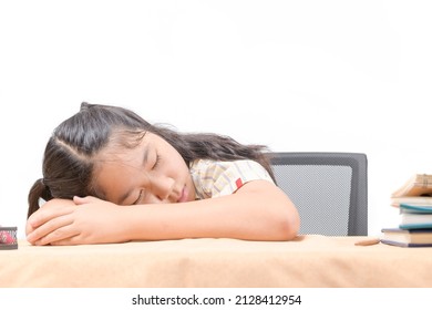 Asian Tired Little Girl Sleeping At Work Desk, Lying On Table Isolated On White, Exhausted Child Schoolgirl Feeling Lazy And Unmotivated, Doing Boring School Homework Assignments,