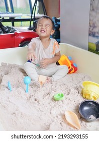 Asian Toddler Boy Enjoy Playing Sand In The Sandbox , Having Fun