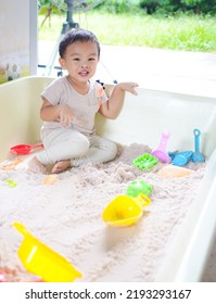 Asian Toddler Boy Enjoy Playing Sand In The Sandbox , Having Fun