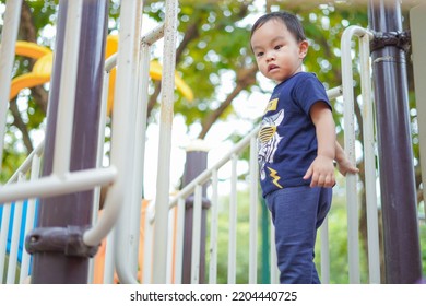 Asian Toddler Boy Enjoy Playing In Playground , Kid Having Fun