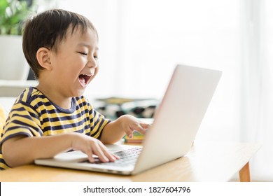 Asian toddler boy student study online education.Kid watching cartoon video streaming.Happy boy learn english online with laptop at home.New normal.Covid-19 coronavirus.Social distancing.stay home. - Powered by Shutterstock