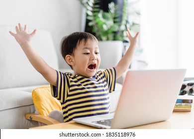 Asian Toddler Boy Student Study Online Education.Kid Watching Cartoon Video Streaming.Happy Boy Learn English Online With Laptop At Home.New Normal.Covid-19 Coronavirus.Social Distancing.stay Home.