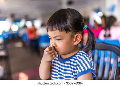 Asian Toddler Girl In 2.3 Years Old In Busy Time With Her Nose In A Resturant