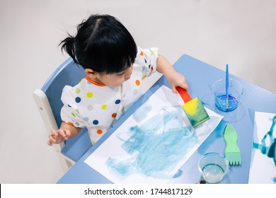 Asian Toddler Girl Is Painting Water Color. Toddler Activity At Home.