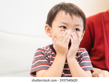 Asian Toddler Little Boy Covering Face With Both Hands Being Afraid Of Watching Scary Movie.Confused Timid Child Feeling Shy Hiding His Emotions.Allergy, Sad, Mask, No Food, Bad Breath, Guilty, Repent