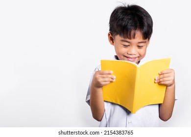 Asian Toddler Smile Happy Wearing Student Thai Uniform Red Pants Standing Holding And Reading A Book In Studio Shot Isolated On White Background, Portrait Little Children Boy Preschool, Back To School