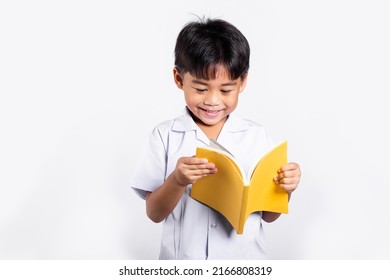 Asian Toddler Smile Happy Wearing Student Thai Uniform Red Pants Standing Holding And Reading A Book In Studio Shot Isolated On White Background, Portrait Little Children Boy Preschool, Back To School