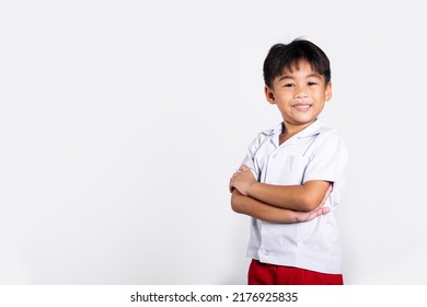 Asian Toddler Smile Happy Wearing Student Thai Uniform Red Pants Stand With Arms Folded In Studio Shot Isolated On White Background, Portrait Little Children Boy Preschool Crossed Arms, Back To School