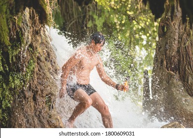 Asian Tourist Recording Himself While Taking Cold Shower In Mountain Waterfall. Water Must Be So Cold That He Gets Goosebumps, But He Is Having Too Much Fun To Observe It.