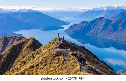 Asian tourists taking photo at Roy's Peak Lake Wanaka New Zealand