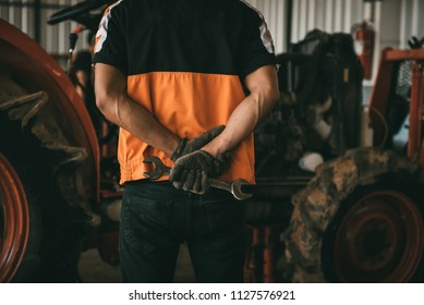 Asian Tractor Laborer Repair Shop With Compress To Prepare For A Complex Tractor.