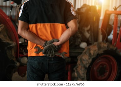 Asian Tractor Laborer Repair Shop With Compress To Prepare For A Complex Tractor.