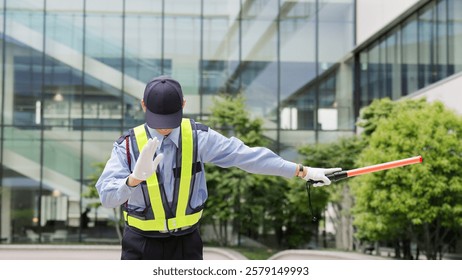 Asian traffic controller directing traffic