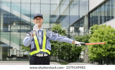 Asian traffic controller directing traffic