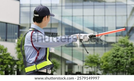 Asian traffic controller directing traffic
