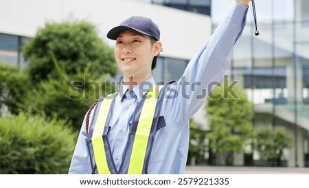Asian traffic controller directing traffic