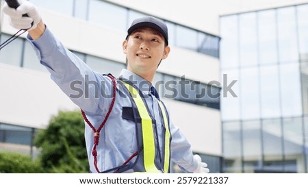 Asian traffic controller directing traffic