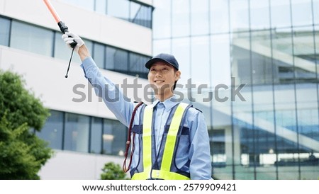 Asian traffic controller directing traffic