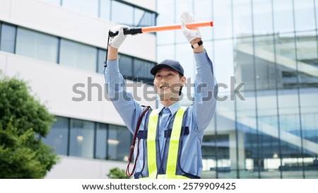 Asian traffic controller directing traffic