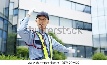 Asian traffic controller directing traffic