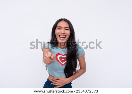 An asian trans woman mocking and taunting someone, pointing with her finger. Making fun of a person while laughing. Isolated on a white backdrop.
