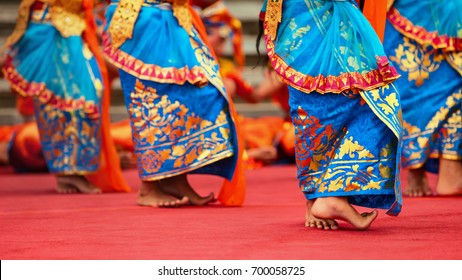 Asian Travel Background. Beautiful Balinese Dancer Woman In Traditional Sarong Costume Dancing Legong Dance. Legs Movements. Arts, Culture Of Indonesian People, Bali Island Festivals.