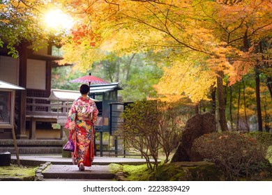 Asian traveler girl in Kimono traditional dress walking in old temple in Autumn season in Kyoto city, Japan