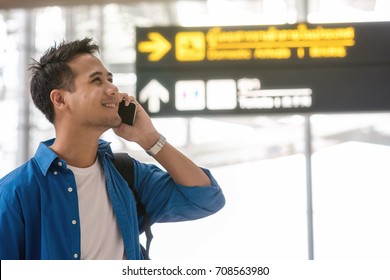 Asian Traveler Using The Smart Mobile Phone And Calling At Modern An Airport, Travel And Transportation With Technology Concept.