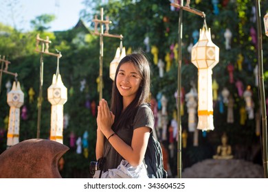 Asian Traveler In Wai Pose During Travel Of Thailand.