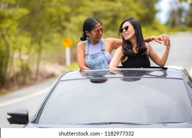 Asian Traveler Woman Stand At Car Sunroof Enjoy Roadtrip