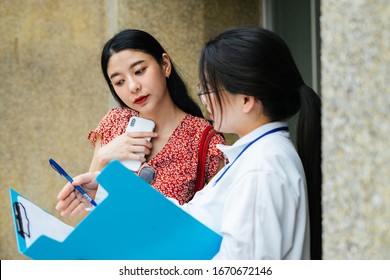 Asian Traveler Woman Talking To Tour Guide Travel Staff In The City.