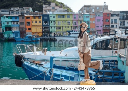 Asian travelers visiting Taiwan Beautiful young woman sightseeing in Keelung's colorful Zhengbin fishing port Popular landmarks and attractions near Taipei City