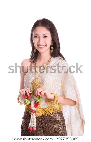 Asian traveller in an ancient thai dress smile with isolated white background