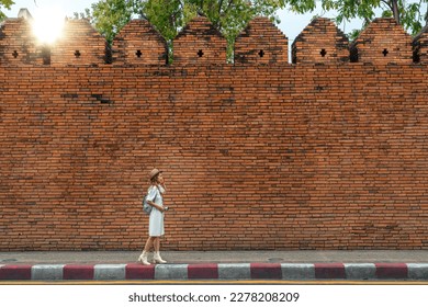 Asian traveller woman walking on the street of Chiang mai old wall in Chiangmai city, Thailand