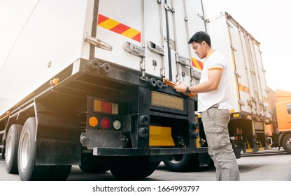 Asian truck driver holding clipboard inspecting safety vehicle maintenance checklist a truck trailer, Road freight industry logistics.